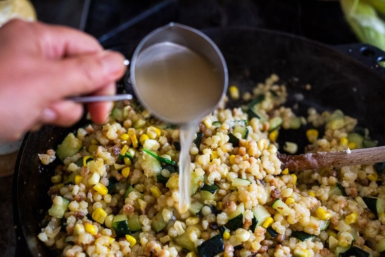 adding pasta water to the pan