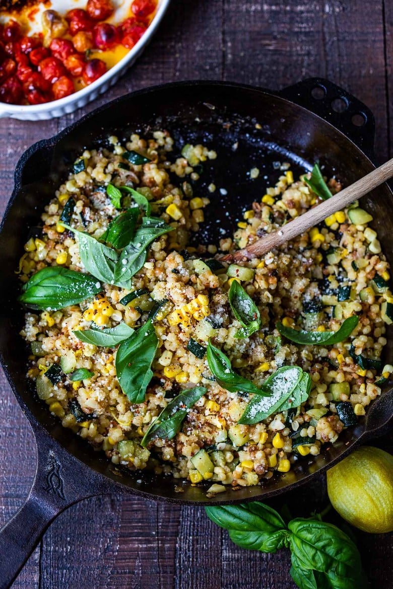 Fregola Sarda with Corn, Zucchini and Basil, sprinkled with pecorino. A fast and easy Italian-inspired meal that comes together in 30 minutes.