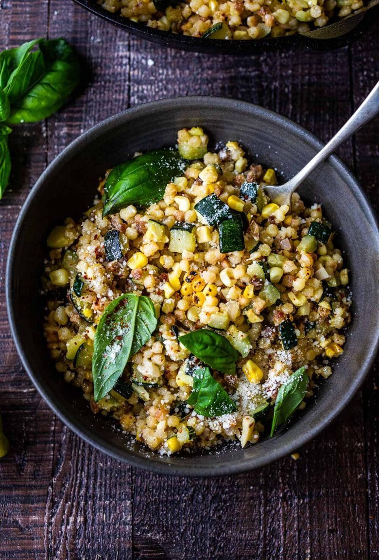 Fregola with Corn, Zucchini and Basil, sprinkled with pecorino. A fast and easy Italian-inspired meal that comes together in 30 minutes.