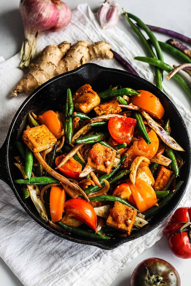 Green Bean and Tofu Stir Fry is full of crunch and flavor.   Spiced up with red curry paste, shallots, ginger and lemongrass for a quick, savory Thai-inspired meal.   Vegan and GF.