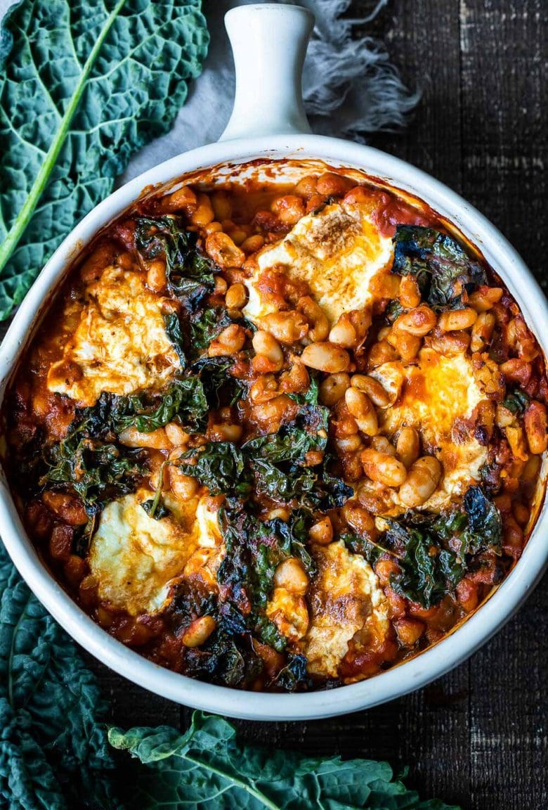 A simple recipe for Italian Baked Beans, made with cannellini beans, kale, and your favorite homemade (or store-bought) Marinara sauce, and baked in the oven until golden and bubbling. A delicious vegetarian main! 