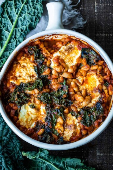 A simple recipe for Italian Baked Beans, made with cannellini beans, kale, and your favorite homemade (or store-bought) Marinara sauce, and baked in the oven until golden and bubbling. A delicious vegetarian main! 