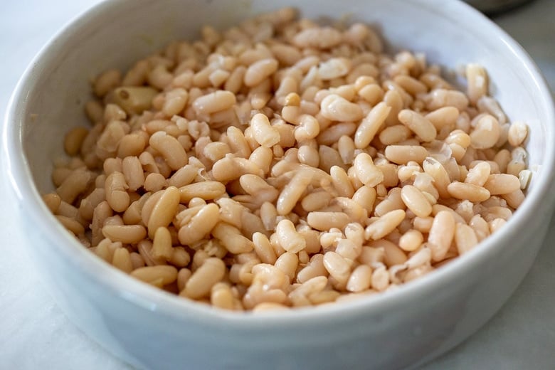 drained cannellini beans in a baking dish 
