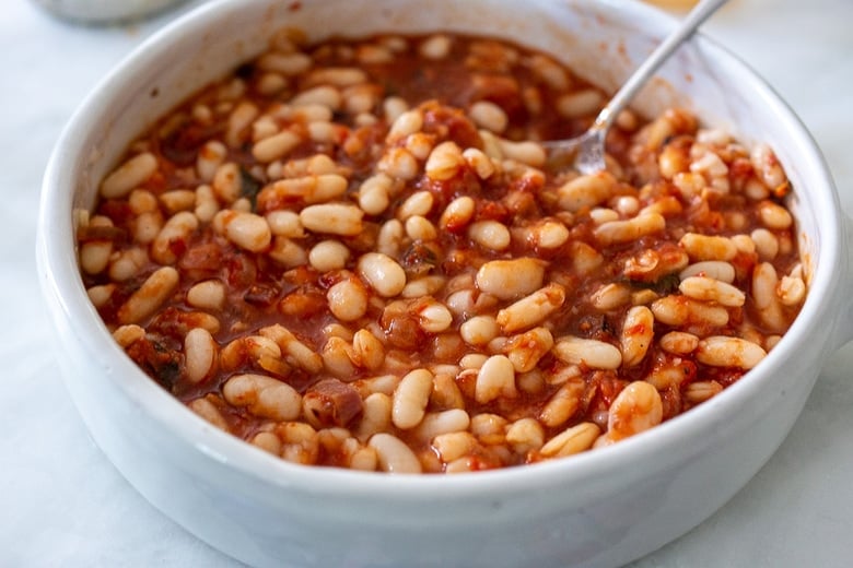 mixing in cannellini beans with the marinara sauce