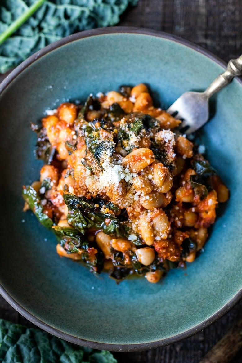 Italian Baked Beans & Greens w/ cannellini beans, lacinato kale & marinara sauce, baked until golden and bubbling. Vegetarinan, Vegan-adaptable.