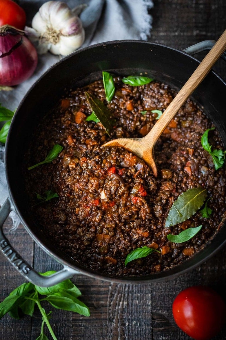 Rich and robust, this plant-based Lentil Bolognese is hearty, "meaty" and full of depth of flavor. Toss it with your favorite pasta, or spoon it over creamy polenta- either way, this simple nourishing vegan meal is one the whole family will enjoy. #lentilbolognese