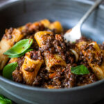 Rich and robust, this plant-based Lentil Bolognese is hearty, "meaty" and full of depth of flavor. Toss it with your favorite pasta, or spoon it over creamy polenta- either way, this simple nourishing vegan meal is one the whole family will enjoy. #lentilbolognese