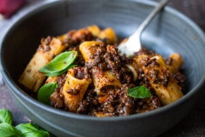 Rich and robust, this plant-based Lentil Bolognese is hearty, "meaty" and full of depth of flavor. Toss it with your favorite pasta, or spoon it over creamy polenta- either way, this simple nourishing vegan meal is one the whole family will enjoy. #lentilbolognese