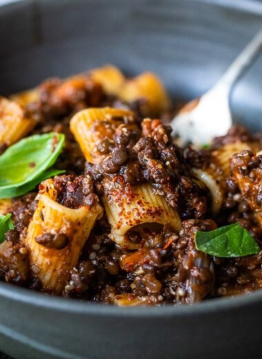 Rich and robust, this plant-based Lentil Bolognese is hearty, "meaty" and full of depth of flavor. Toss it with your favorite pasta, or spoon it over creamy polenta- either way, this simple nourishing vegan meal is one the whole family will enjoy. #lentilbolognese