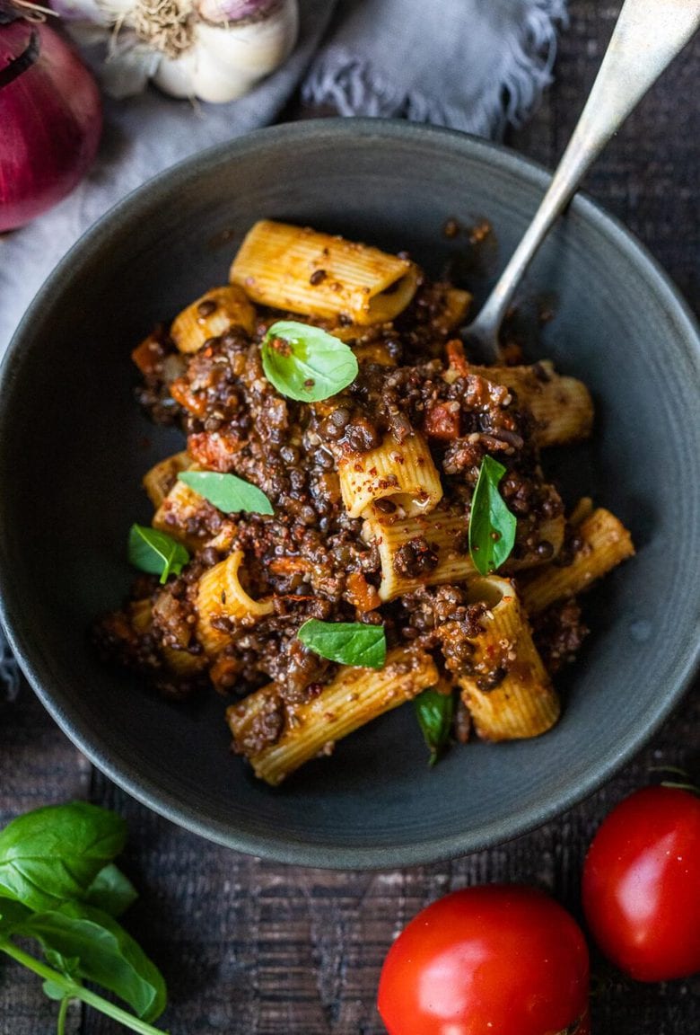 Rich and robust, this plant-based Lentil Bolognese is hearty, "meaty" and full of depth of flavor. Toss it with your favorite pasta, or spoon it over creamy polenta- either way, this simple nourishing vegan meal is one the whole family will enjoy. #lentilbolognese