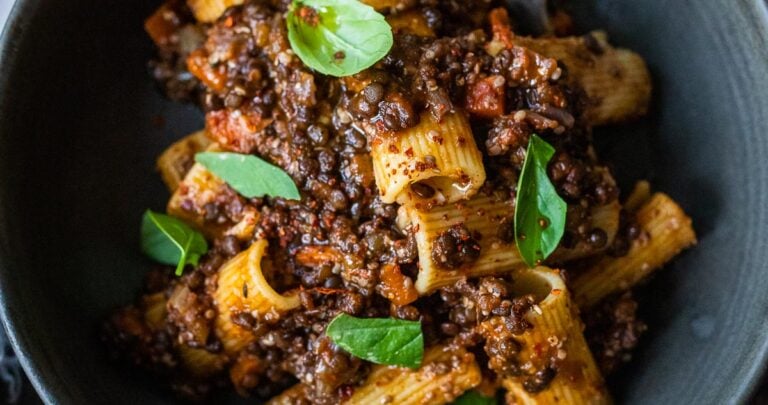 Rich and robust, this plant-based Lentil Bolognese is hearty, "meaty" and full of depth of flavor. Toss it with your favorite pasta, or spoon it over creamy polenta- either way, this simple nourishing vegan meal is one the whole family will enjoy. #lentilbolognese