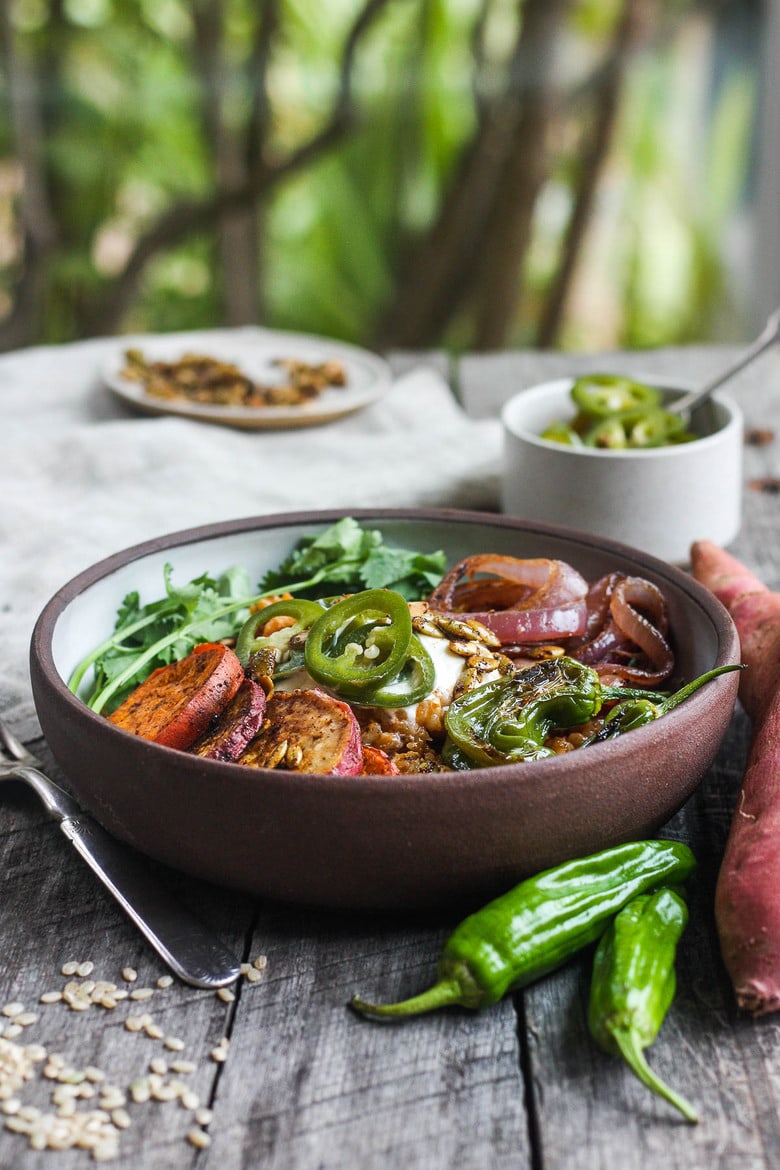 Healthy and flavorful Mexican Rice made with brown rice, topped with sheet-pan roasted yams, red onions, and shishito peppers.  Top with pickled jalapeños and pumpkin seeds for a comforting delicious vegan meal. #mexicanrice