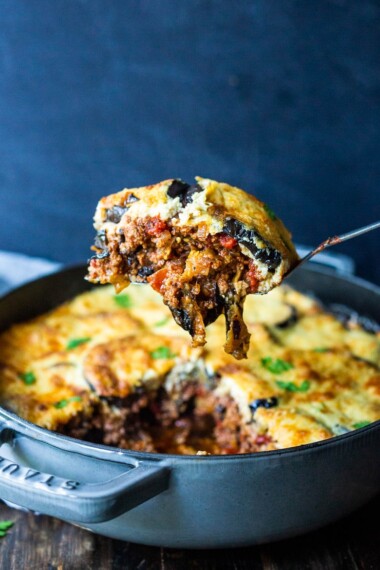 An authentic, delicious recipe for Eggplant Moussaka- with a Tomato lamb sauce, and creamy béchamel sauce. Vegetarian Adaptable! Can be made ahead and baked prior to serving.#eggplantmoussaka