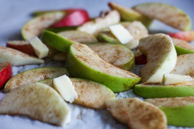 dotting apples with butter before baking 