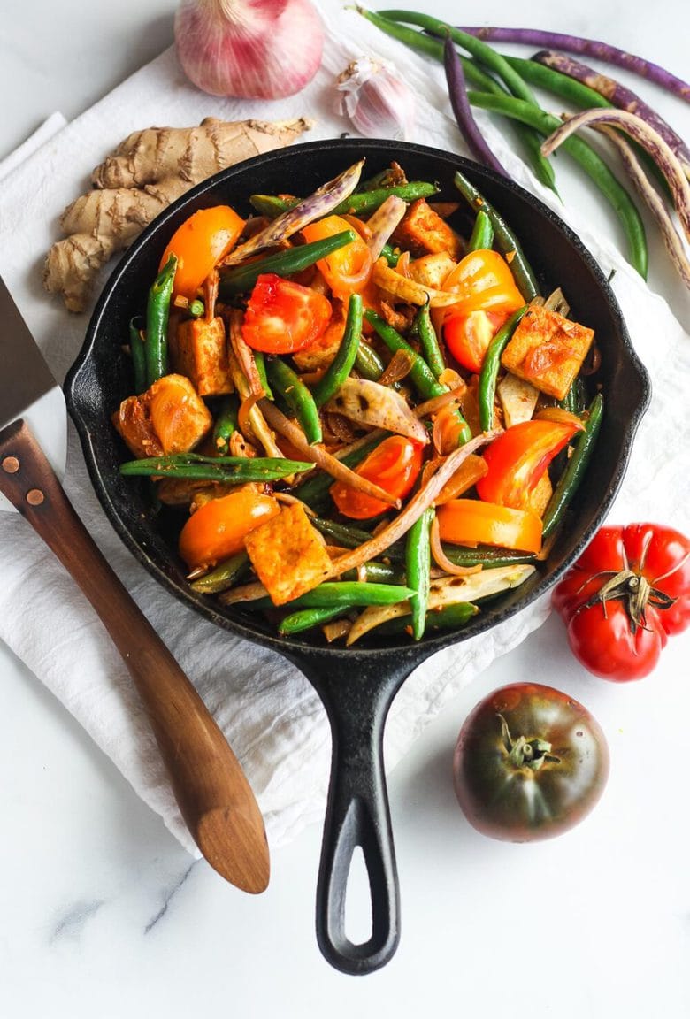 Thai Green Bean and Tofu Stir Fry is full of crunch and flavor. Spiced up with red curry paste, shallots, ginger and lemongrass for a quick and savory 30 minute meal. Vegan and GF.