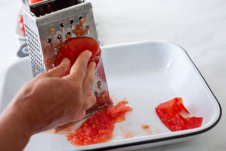Grating a fresh tomato.
