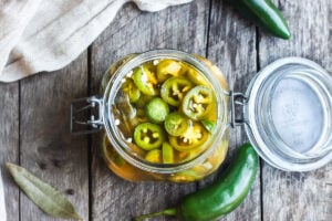 How to make easy homemade Pickled Jalapeños -a deliciously tangy, sweet and spicy accent to tacos, burgers, soups, burritos, and more!