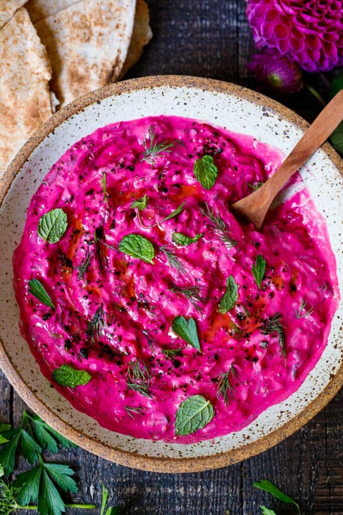 Vibrant Beet Tzatziki made with grated beets, cucumber, Greek yogurt and fresh herbs- a festive appetizer or complementary side dish to Mediterranean-inspired meals.  Vegan-adaptable!