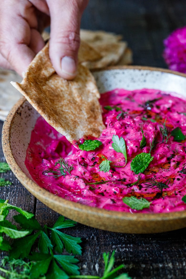 Vibrant Beet Tzatziki made with grated beets, cucumber, Greek yogurt and fresh herbs- a festive appetizer or complementary side dish to Mediterranean-inspired meals.  Vegan-adaptable!