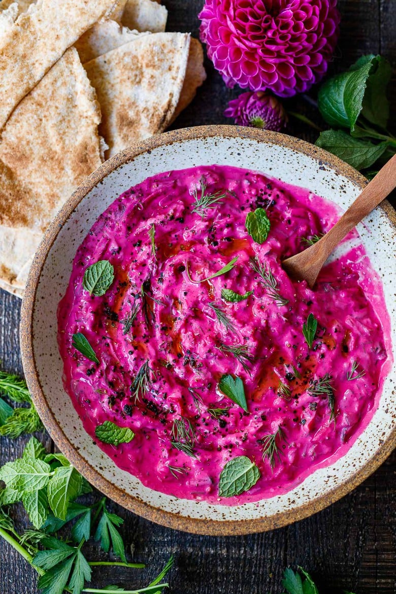 Vibrant Beet Tzatziki made with grated beets, cucumber, Greek yogurt and fresh herbs- a festive appetizer or complementary side dish to Mediterranean-inspired meals.  Vegan-adaptable!