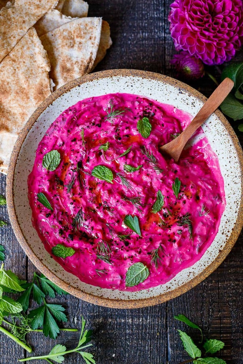 Vibrant Beet Tzatziki made with grated beets, cucumber, Greek yogurt and fresh herbs- a festive appetizer or complementary side dish to Mediterranean-inspired meals.  Vegan-adaptable!