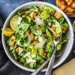 How to make a Classic Caesar Salad from scratch with a rich and tangy homemade Caesar dressing, parmesan cheese and hand-torn croutons.