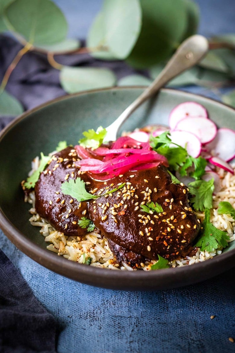 A flavorful recipe for Chicken Mole Negro is made with Black Mole Sauce- smoky, spicy and nutty with dried chilies, and a hint of chocolate. A flavorful Oaxacan-inspired meal. #mole #molenegro 