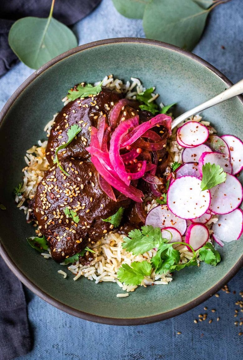 A flavorful recipe for Chicken Mole Negro is made with Black Mole Sauce- smoky, spicy and nutty with dried chilies, and a hint of chocolate. A flavorful Oaxacan-inspired meal. #mole #molenegro