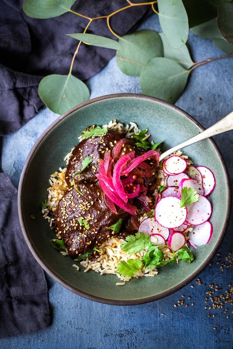 A flavorful recipe for Chicken Mole Negro is made with Black Mole Sauce- smoky, spicy and nutty with dried chilies, and a hint of chocolate. A flavorful Oaxacan-inspired meal. #mole #molenegro 