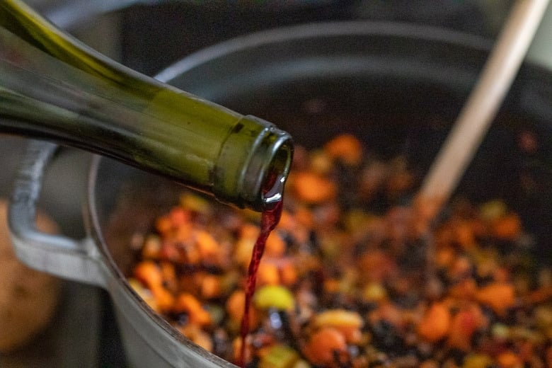 pouring wine into the pot