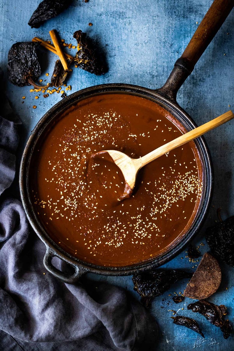 mole sauce in a pan with a wood spoon.