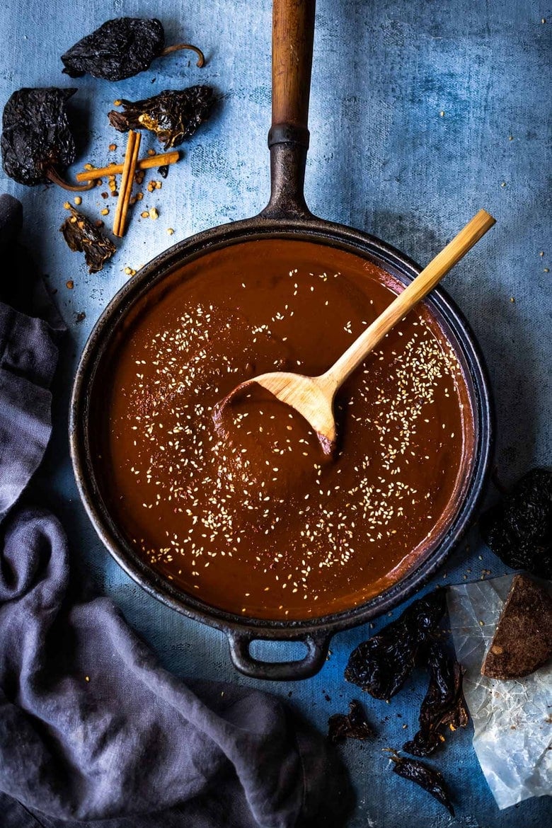 This authentic Mole Sauce recipe is richly flavored, deep, and complex! Made with dried chilies, warm Mexican spices, seeds, and a hint of bittersweet chocolate, it has a perfect balance- perfect for Mole Chicken, pulled meats, enchiladas, or tamales.