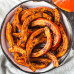 Tender and delicious Roasted Red Kuri Squash baked with an ancho chili powder -maple rub. A perfect fall and winter side dish. Easy to make with very little hands-on time. Vegan and Gluten-free.