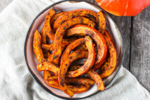 Tender and delicious Roasted Red Kuri Squash baked with an ancho chili powder -maple rub.  A perfect fall and winter side dish.  Easy to make with very little hands-on time. Vegan and Gluten-free. 