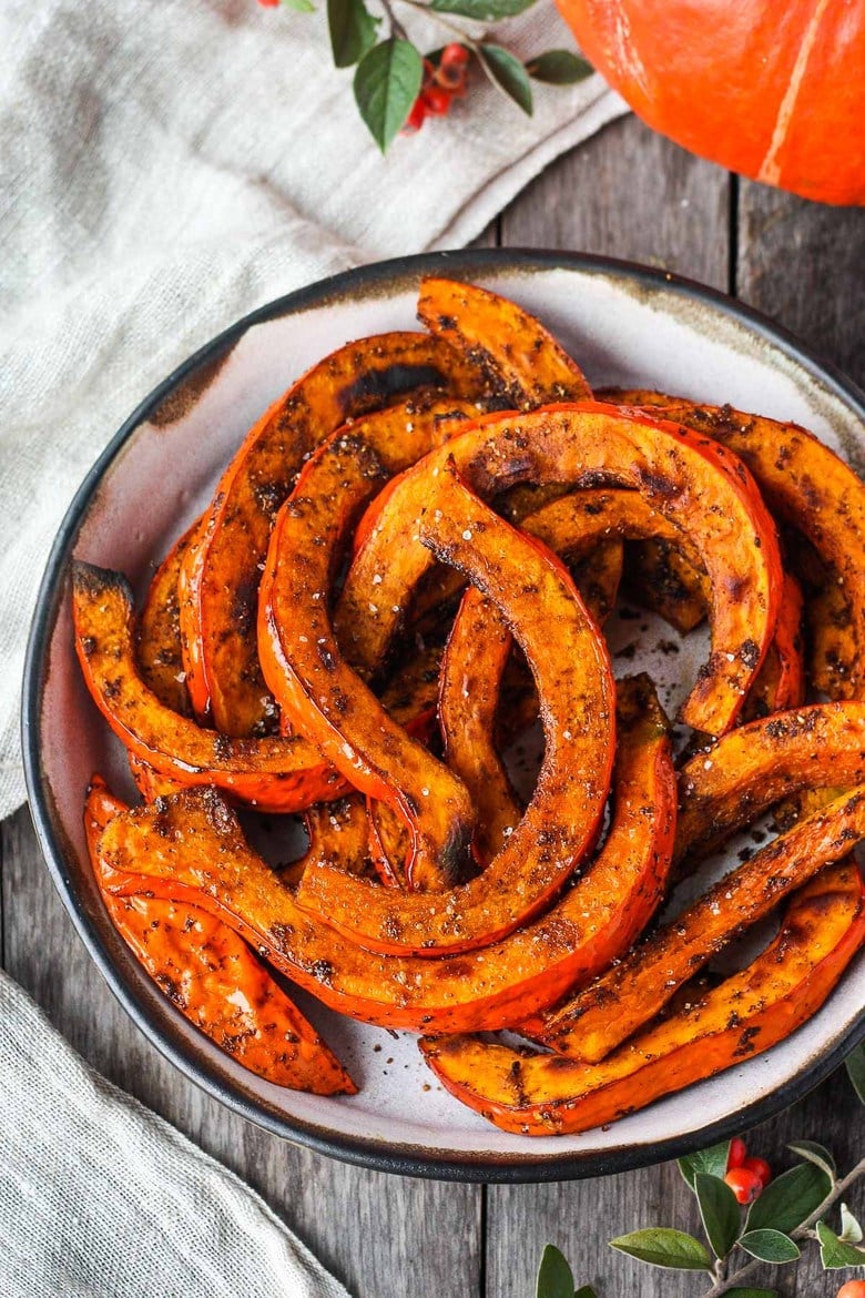 Tender and delicious Roasted Red Kuri Squash baked with an ancho chili powder -maple rub.  A perfect fall and winter side dish.  Easy to make with very little hands-on time. Vegan and Gluten-free. 