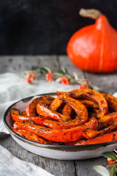 Tender and delicious Roasted Red Kuri Squash baked with an ancho chili powder -maple rub.  A perfect fall and winter side dish.  Easy to make with very little hands-on time. Vegan and Gluten-free. 