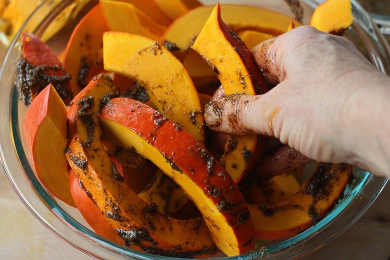 rubbing spice mix on the squash