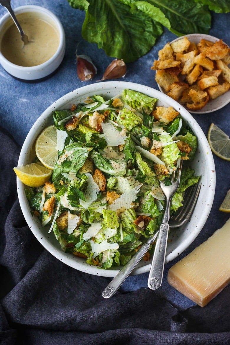How to make a classic Caesar salad with a creamy tangy dressing, parmesan cheese and homemade croutons. #caesar