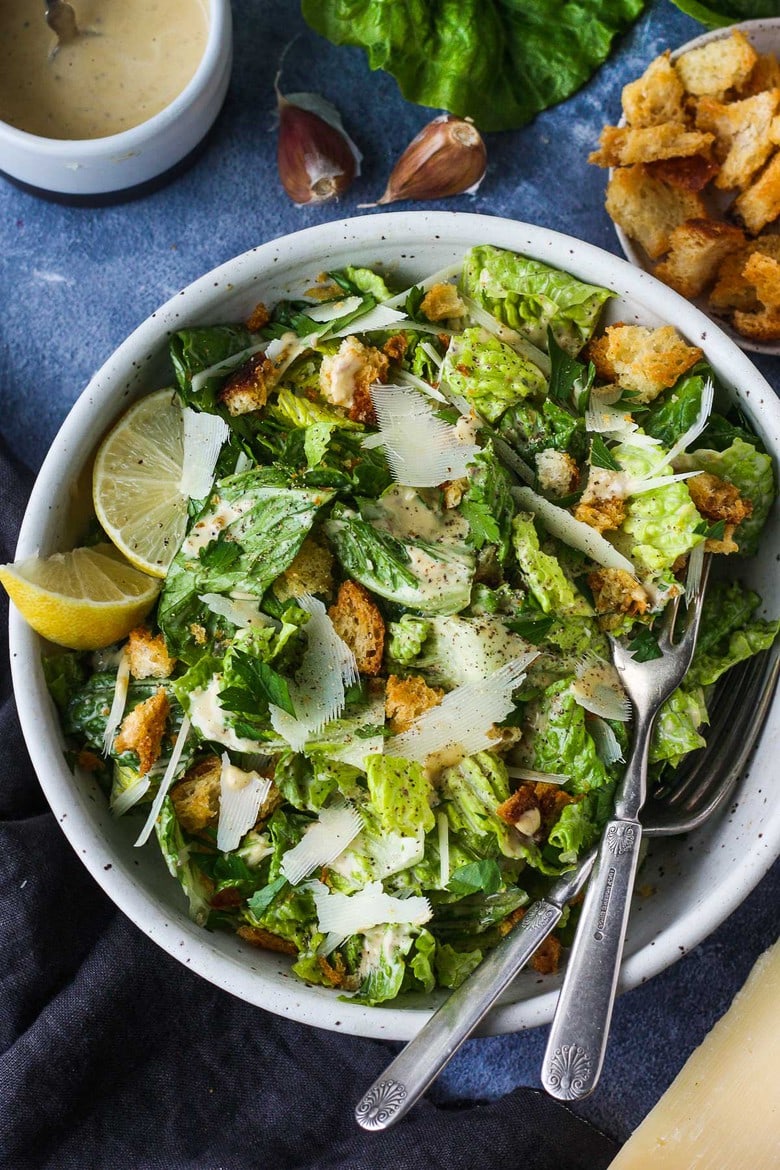 How to make a classic Caesar salad with a creamy tangy dressing, parmesan cheese and homemade croutons. 