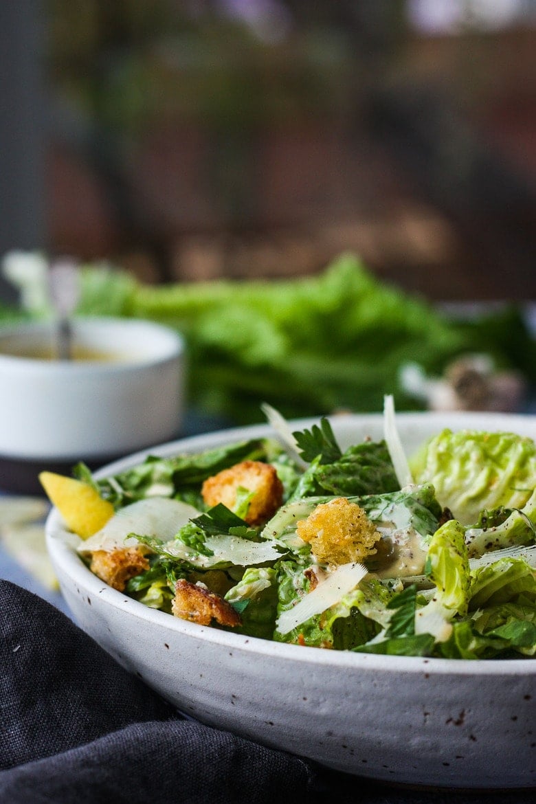 How to make a classic Caesar salad with homeade creamy Caesar dressing, parmesan cheese and homemade croutons. #caesar