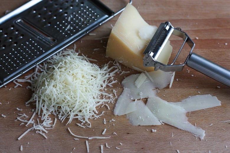 Grating parmesan cheese.