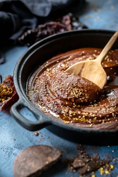 This authentic Mole Sauce recipe is richly flavored, deep, and complex! Made with dried chilies, warm Mexican spices, seeds, and a hint of bittersweet chocolate, it has a perfect balance- perfect for Mole Chicken, pulled meats, enchiladas, or tamales.