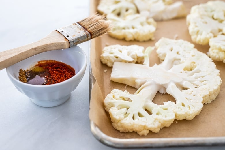 place cauliflower steaks on a parchment lined sheet pan