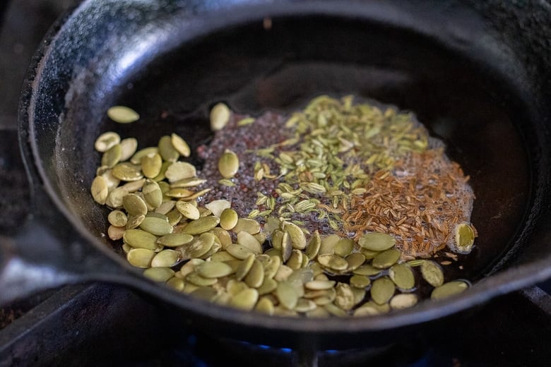 toast the spices and pumpkin seeds in a pan