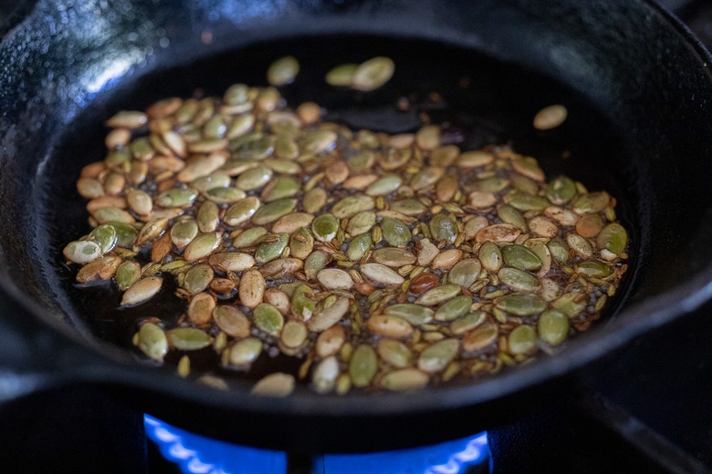 toasted spices and pumpkin seeds in a pan