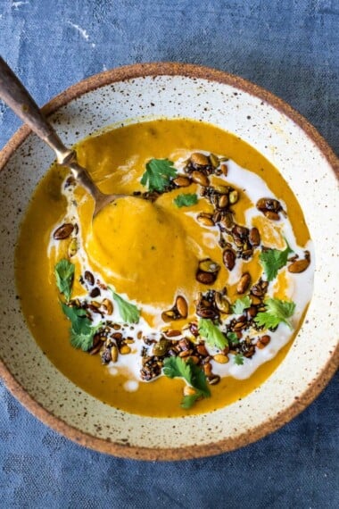 Thick and creamy Pumpkin soup with coconut milk, and warming Indian spices. Vegan and Gluten-free. Use roasted pumpkin or canned pumpkin puree!
