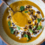 Thick and creamy Pumkin soup with coconut milk, and warming Indian spices. Vegan and Gluten free. Use roasted pumpkin or canned pumkin puree!