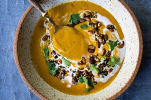 Thick and creamy Pumkin soup with coconut milk, and warming Indian spices. Vegan and Gluten free. Use roasted pumpkin or canned pumkin puree!