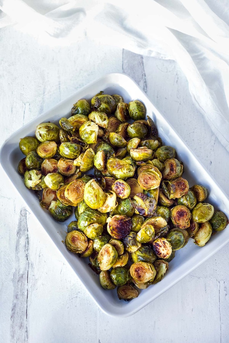 A simple recipe for Roasted Brussels Sprouts with garlic and balsamic- tender, carmelized and full of toasty deep flavor.  An easy vegan side dish ready in 30 minutes! 