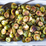 A simple recipe for Roasted Brussel Sprouts with garlic and balsamic- tender, carmelized and full of toasty deep flavor.  An easy vegan side dish ready in 30 minutes! 